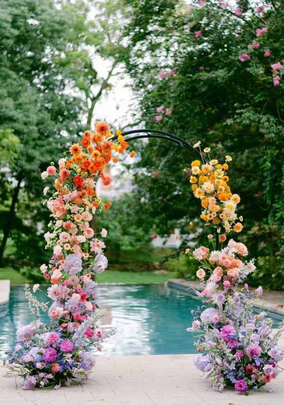 fall floral arch by pool