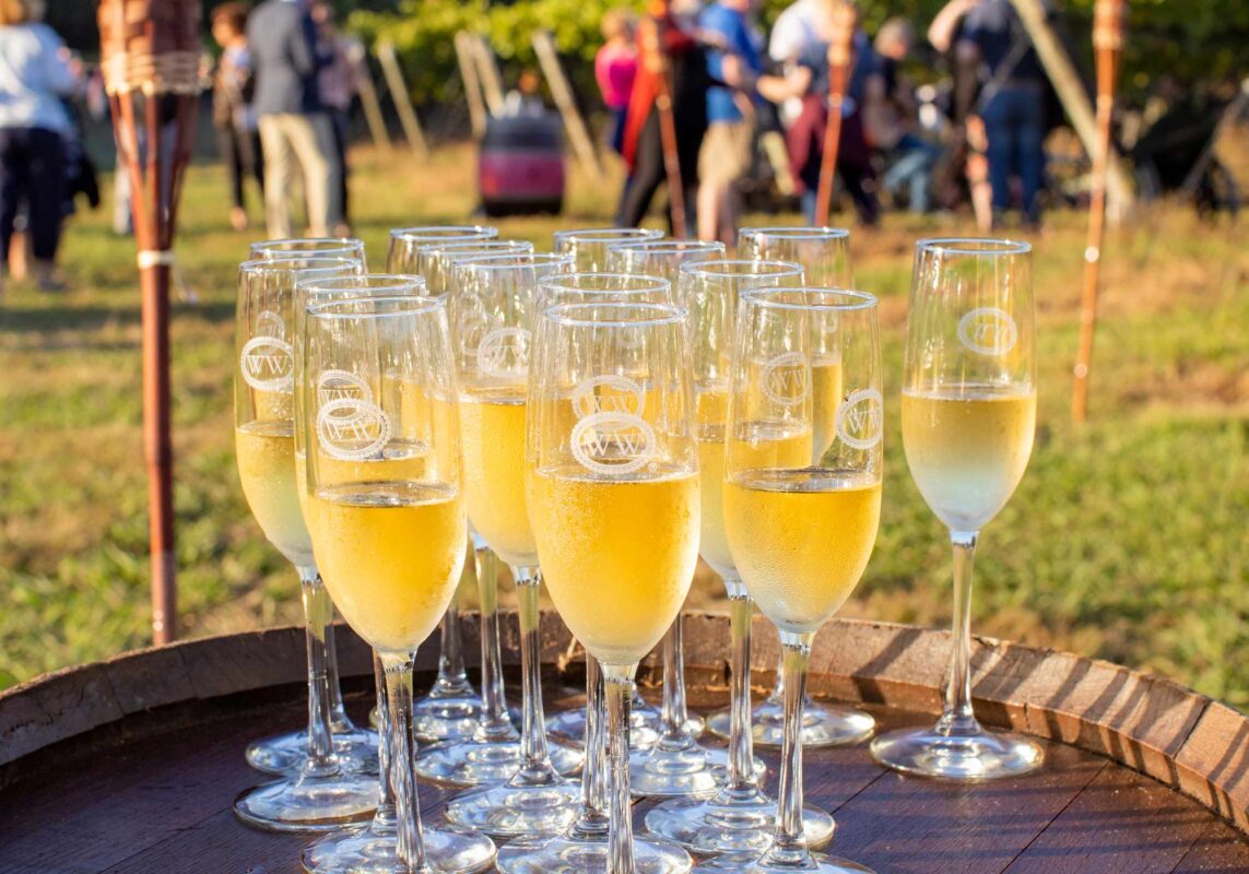 Sparkling wine in flutes on wine barrel table at Williamsburg Winery Wedding