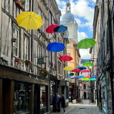 European honeymoon destination. City street with floating umbrellas.