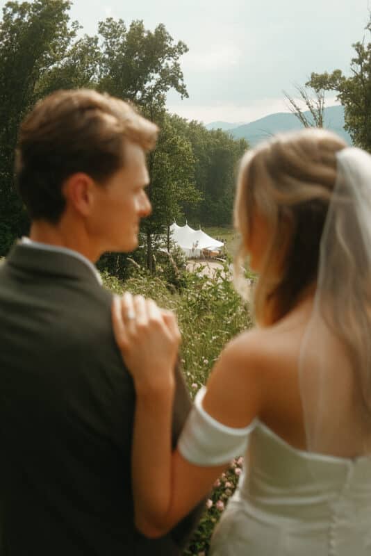 bride and groom looking off at mountains
