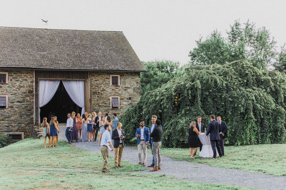 Sylvanside Farm wedding party enjoying cocktails outside barn