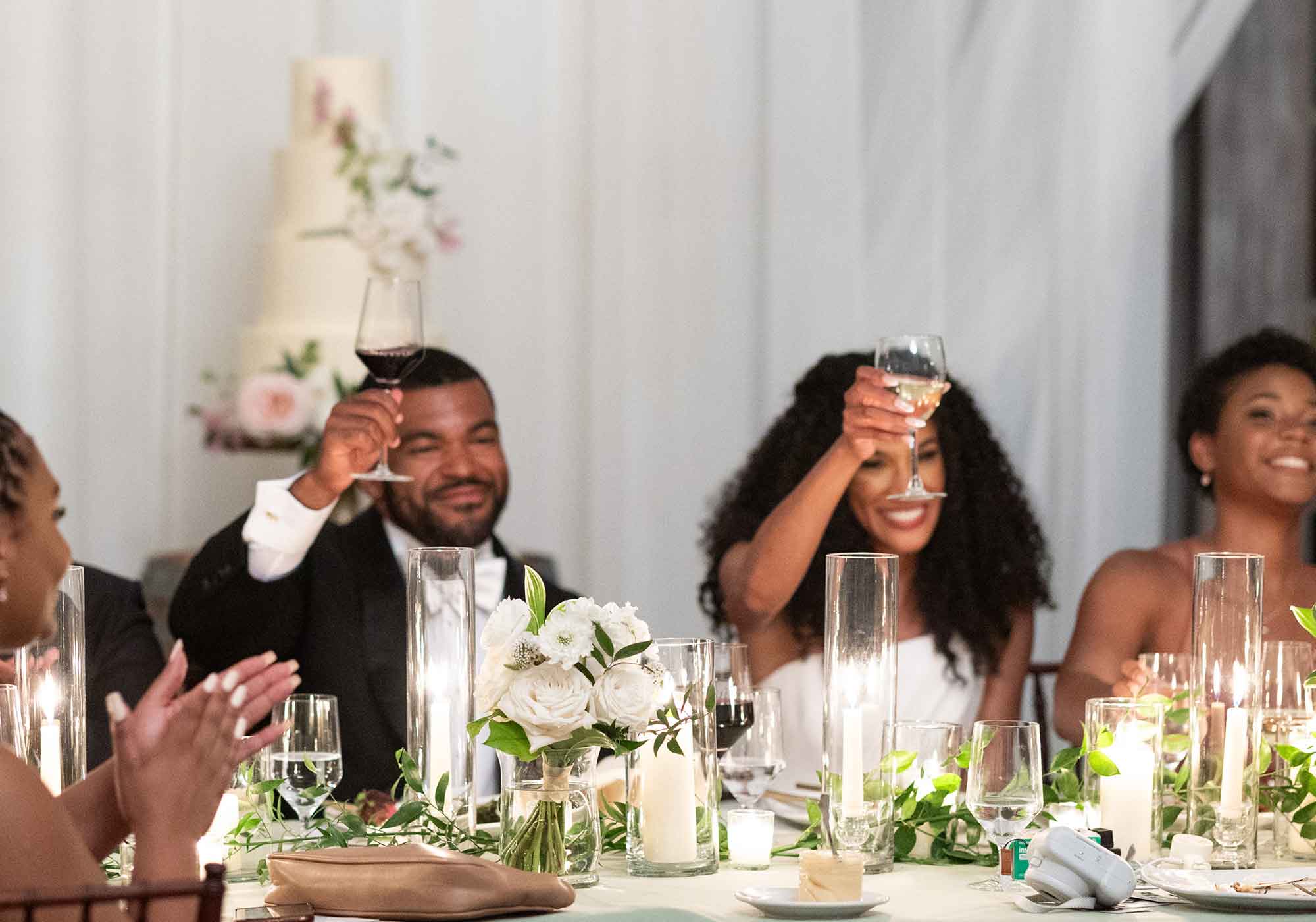 black bride and groom toasting with wine glasses at wedding reception