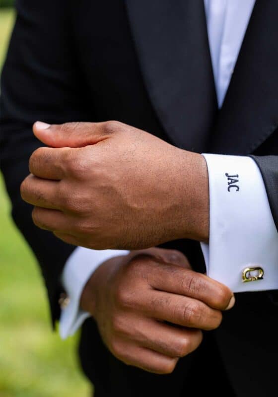 detail of groom cufflinks and monogramed cuff