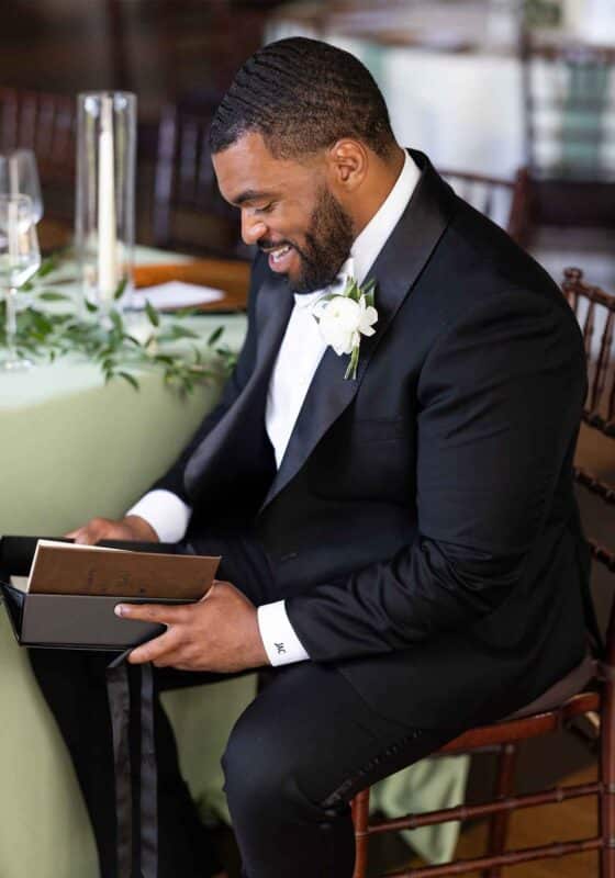 black groom reading letter from bride