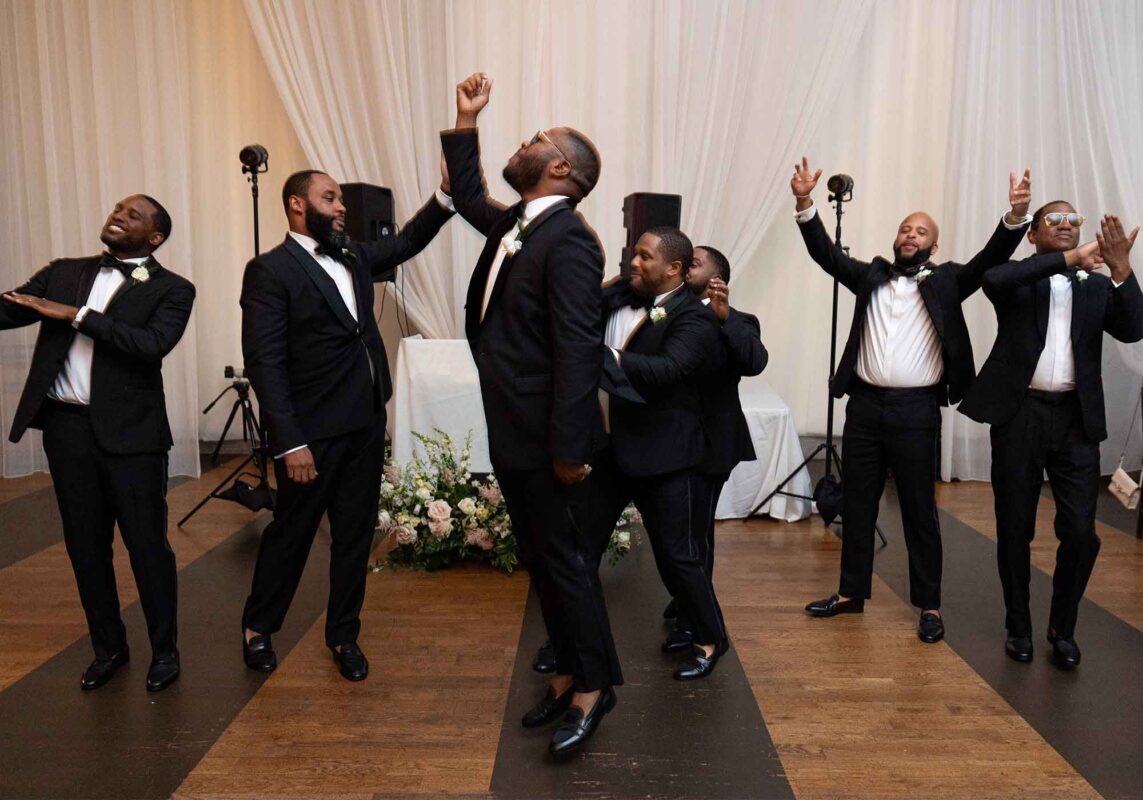 black wedding reception all groomsmen dancing
