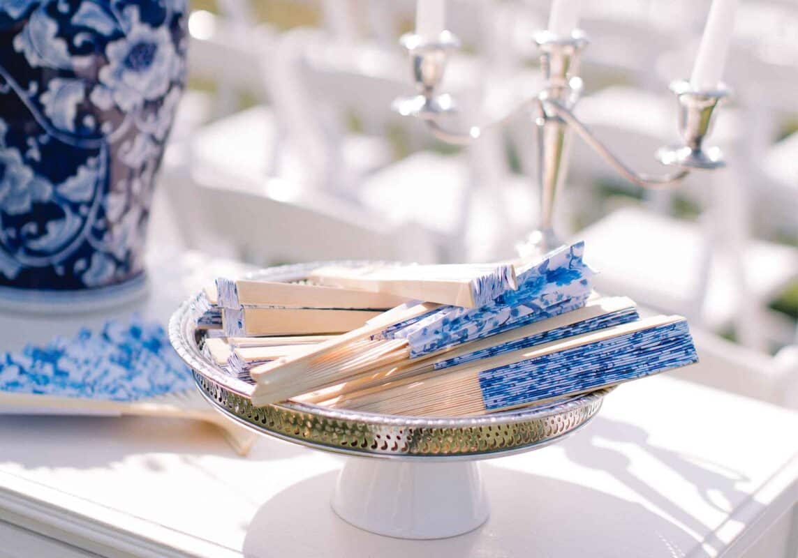 This blue & white vineyard wedding included chinoiserie inspired wedding favors such as patterned paper fans.