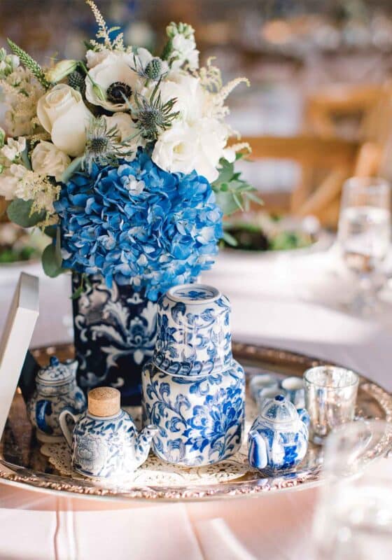 This blue and white vineyard wedding used hydrangeas and white roses in trendy chinoiserie vases.