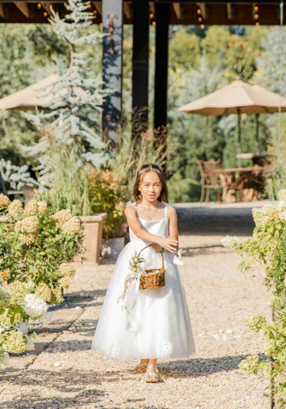 flower girl tossing petals on aisle