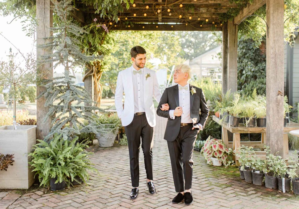 Grooms walking together at outdoor summer wedding in Virginia wine country