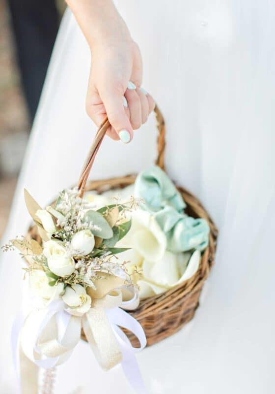 flower girl basket decorated with fresh blooms and ribbon