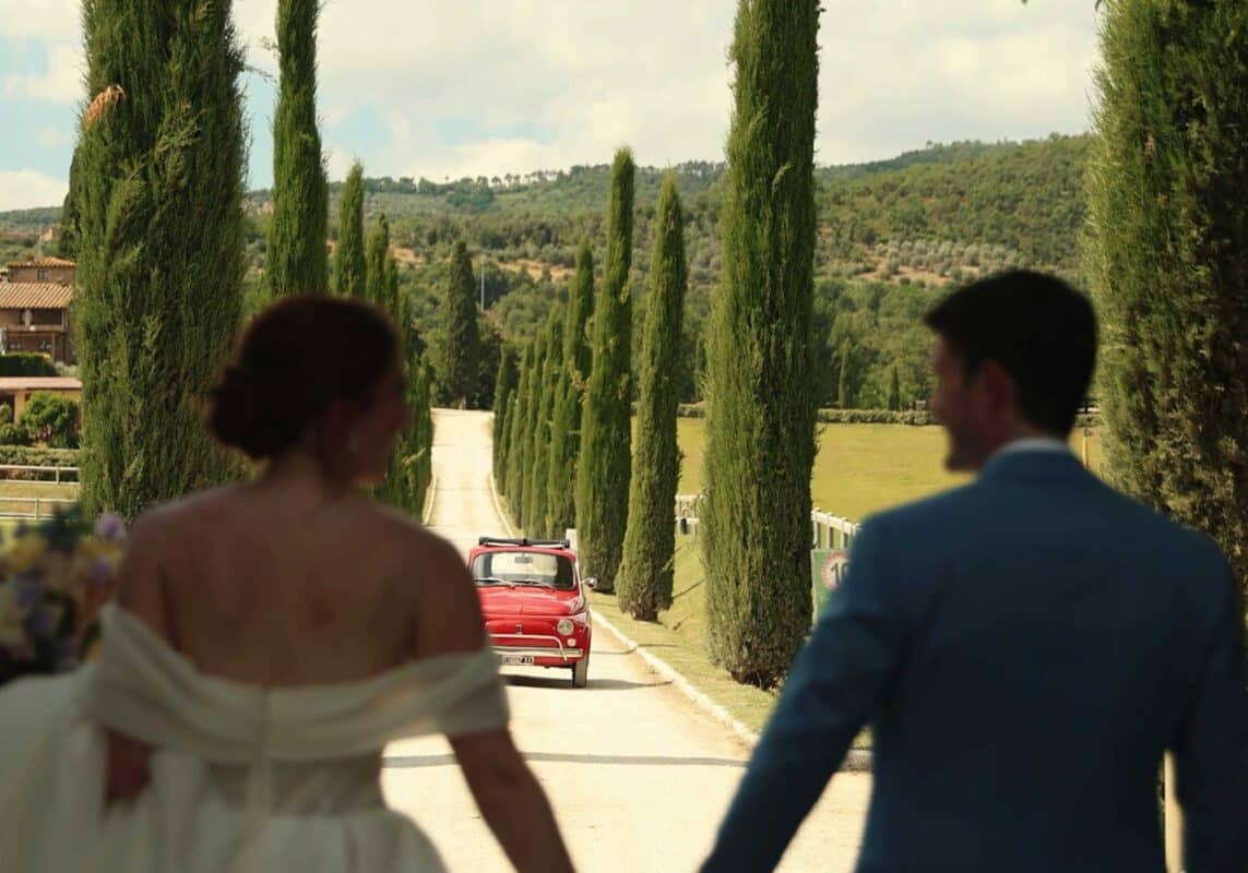 Wedding couple outside holding hands. Schornberg Wedding Films