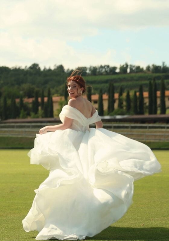 Bride running on vast lawn. Schornberg Wedding Films