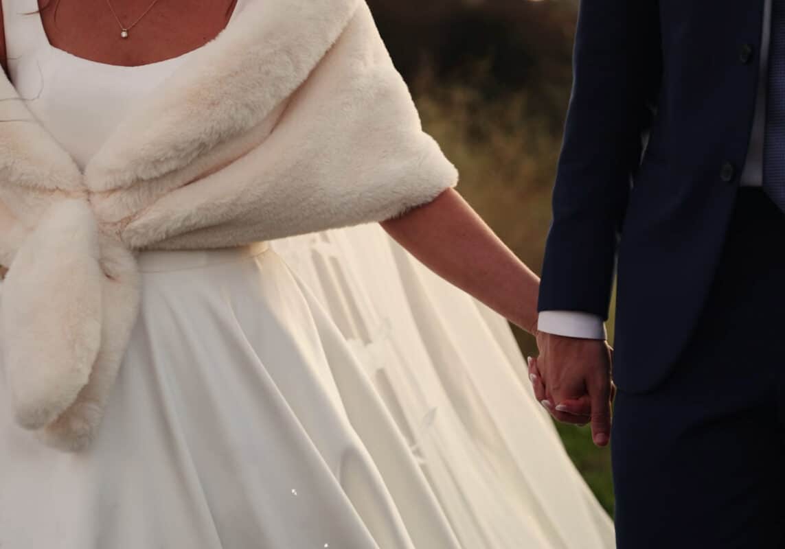 bride and groom holding hands. Schornberg Wedding Films